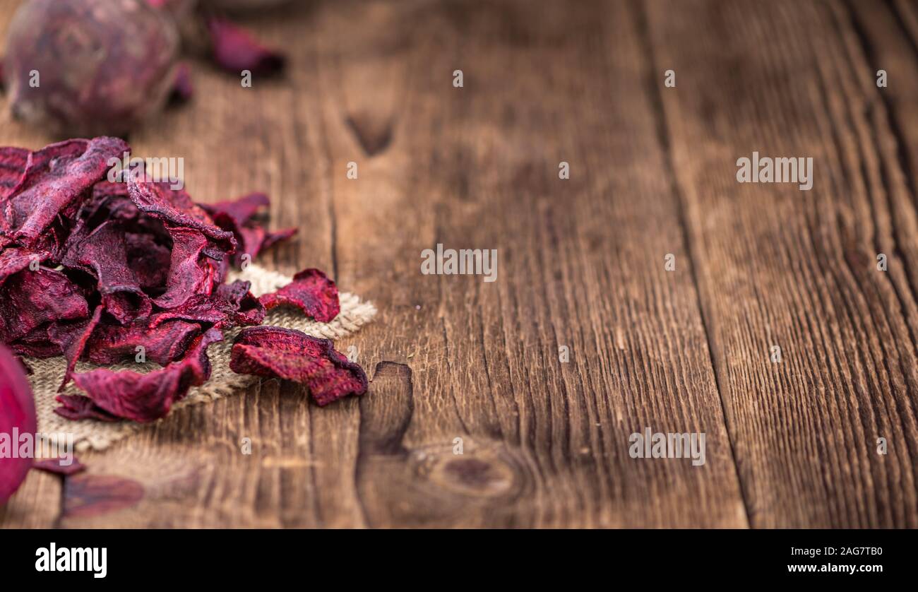 Wooden table with Beetroot Chips (detailed close-up shot; selective focus) Stock Photo