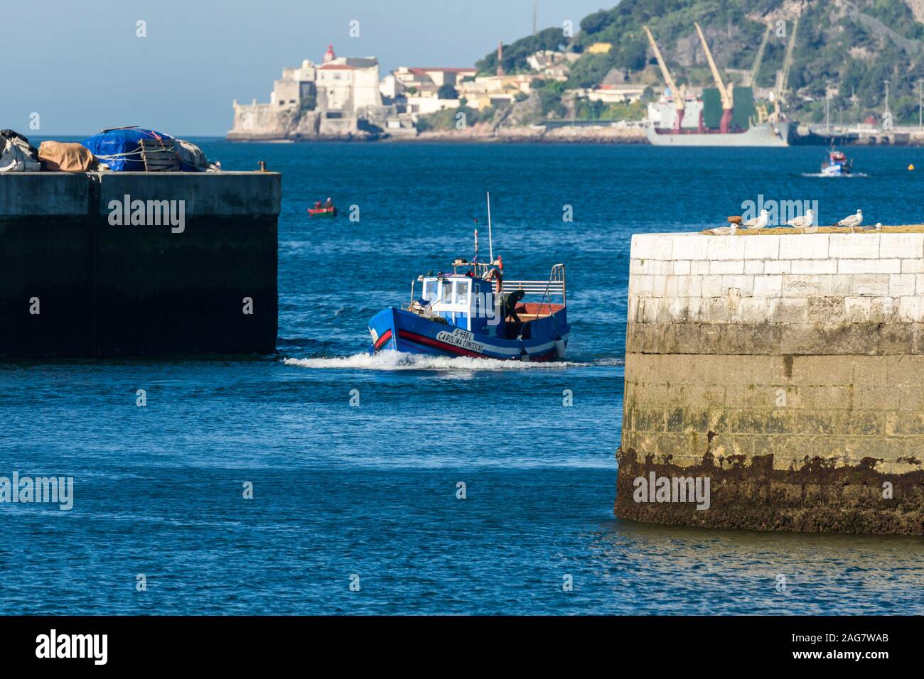 return of fishing boats to the fish market in the port of Setubal Portugal Stock Photo