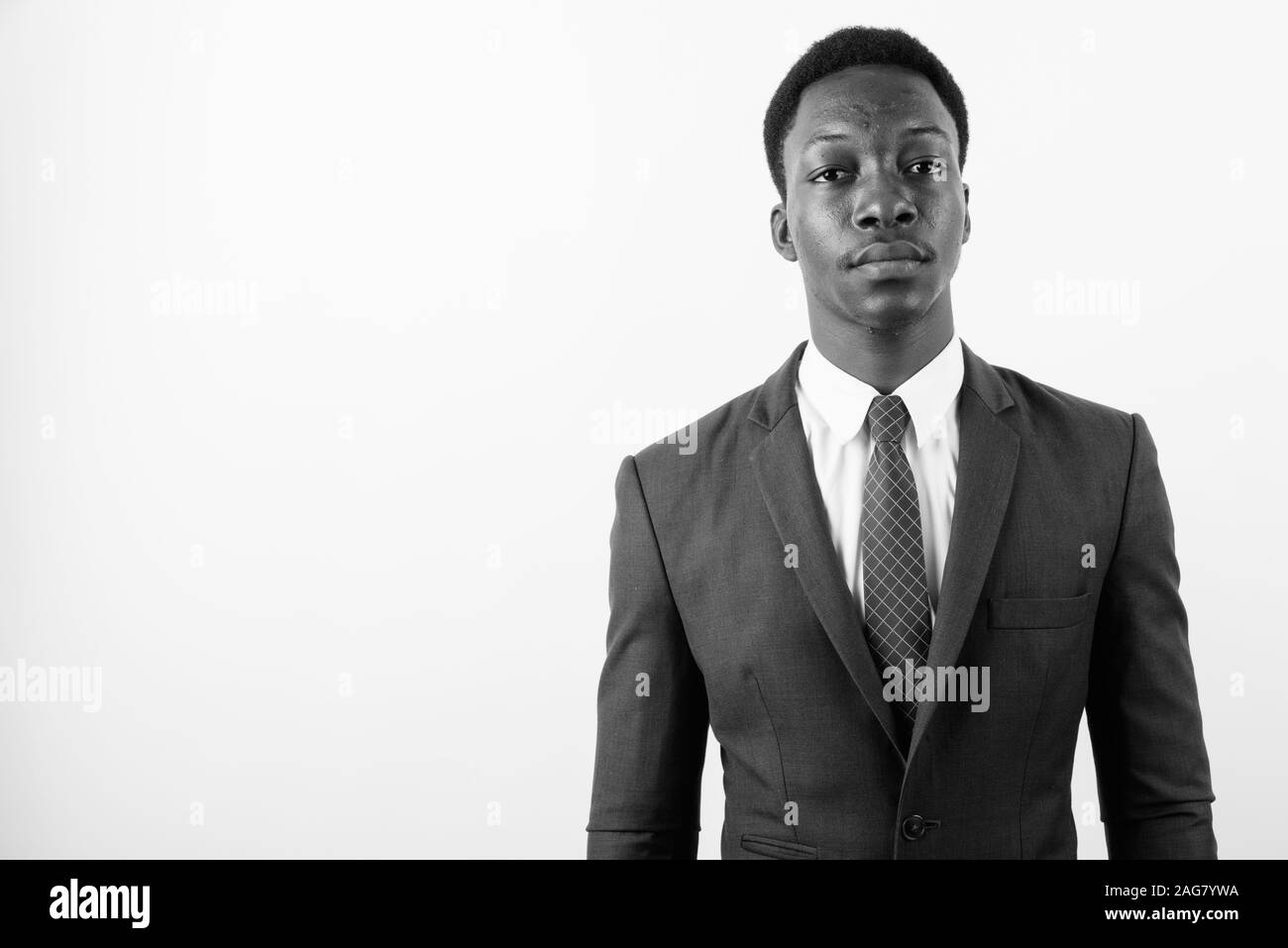 Young handsome African businessman wearing suit against white ...
