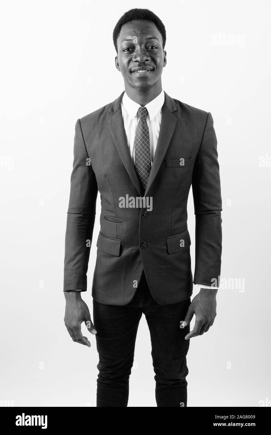 Young handsome African businessman wearing suit against white ...