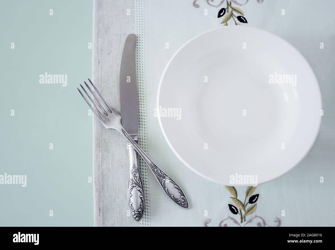 A white empty plate on a linen napkin Stock Photo