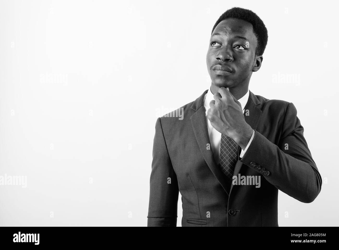 Young handsome African businessman wearing suit against white ...