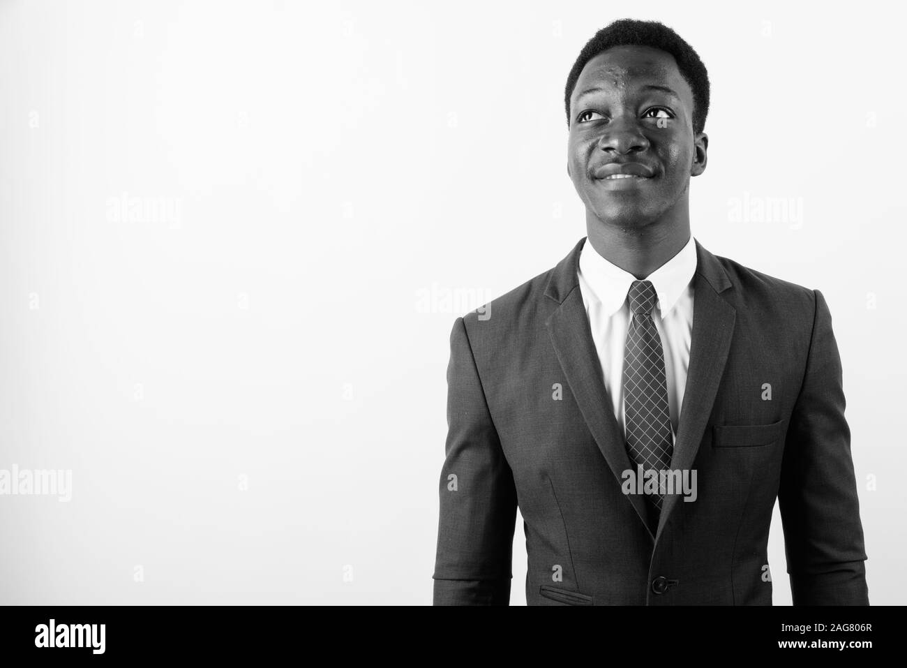 Young handsome African businessman wearing suit against white ...
