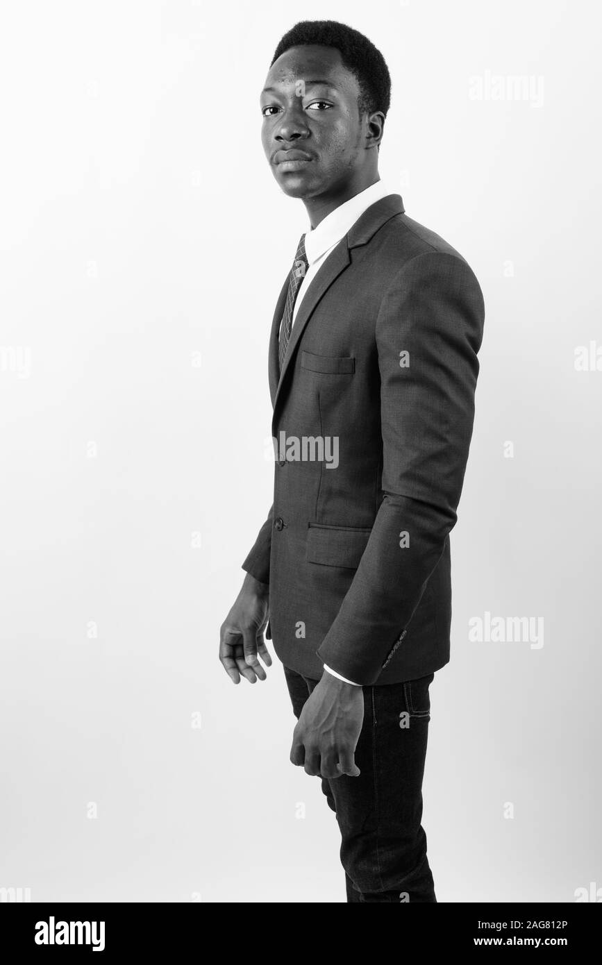 Young handsome African businessman wearing suit against white ...