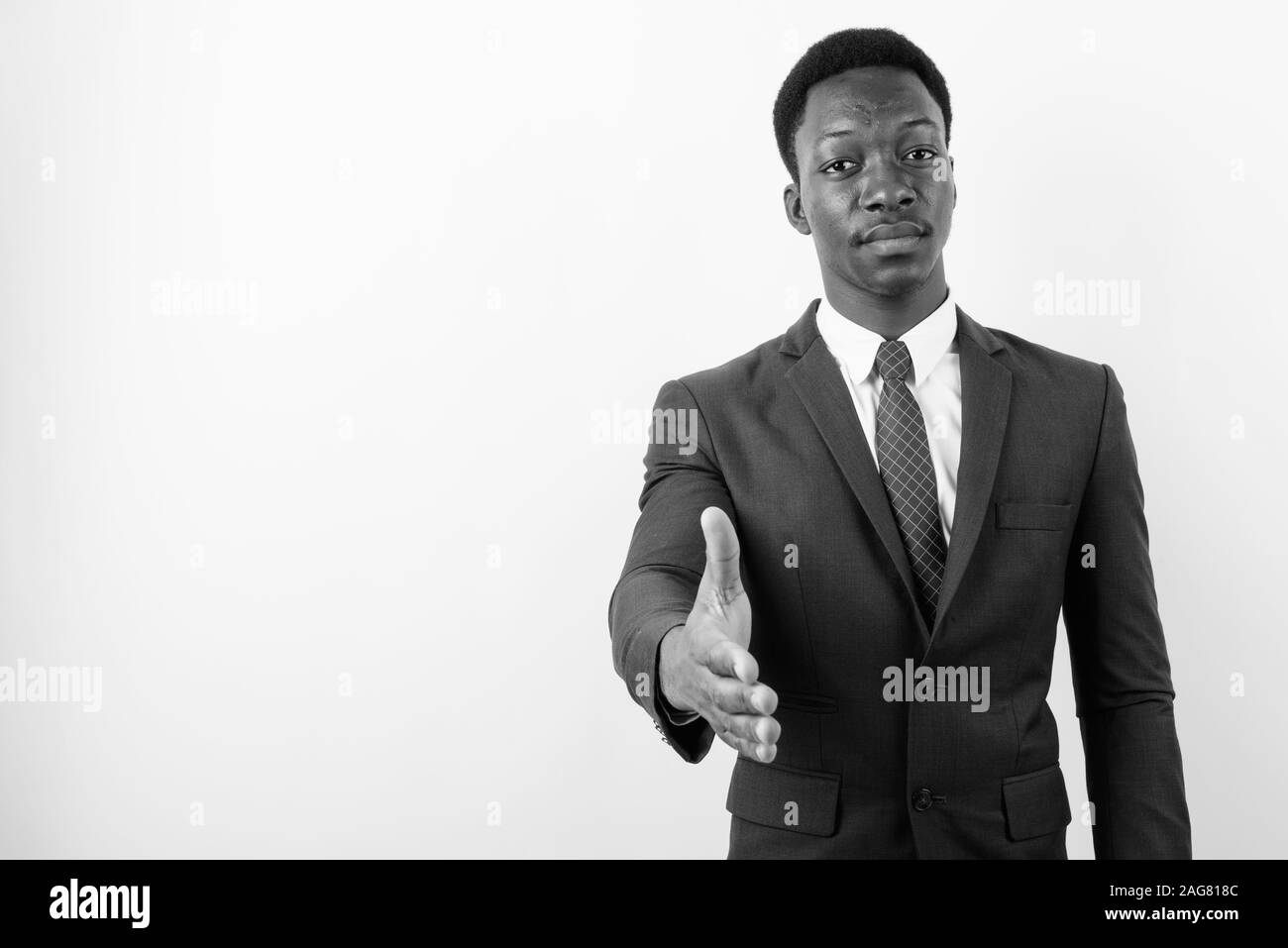 Young handsome African businessman wearing suit against white ...