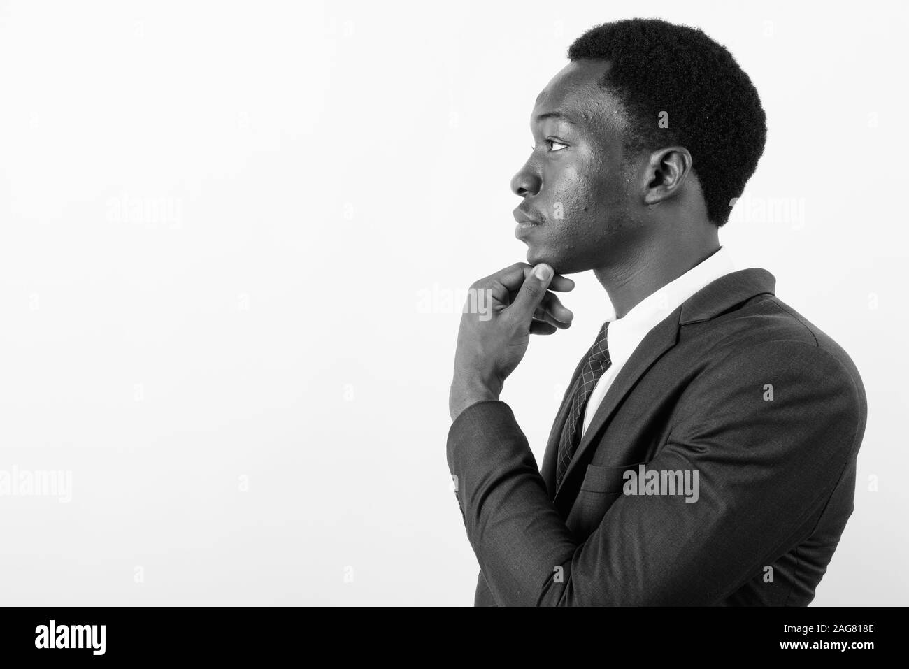 Young handsome African businessman wearing suit against white ...