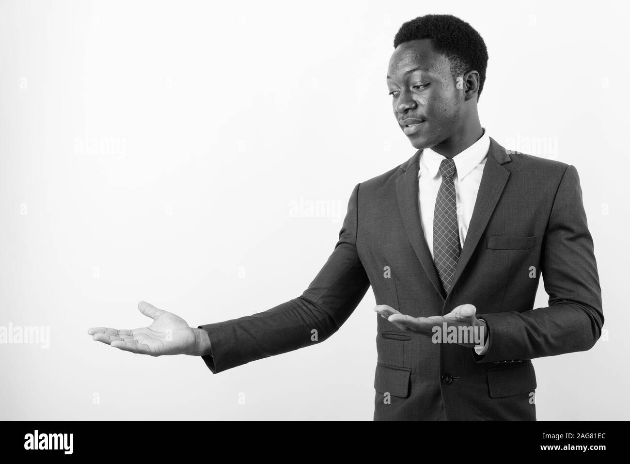 Young handsome African businessman wearing suit against white ...