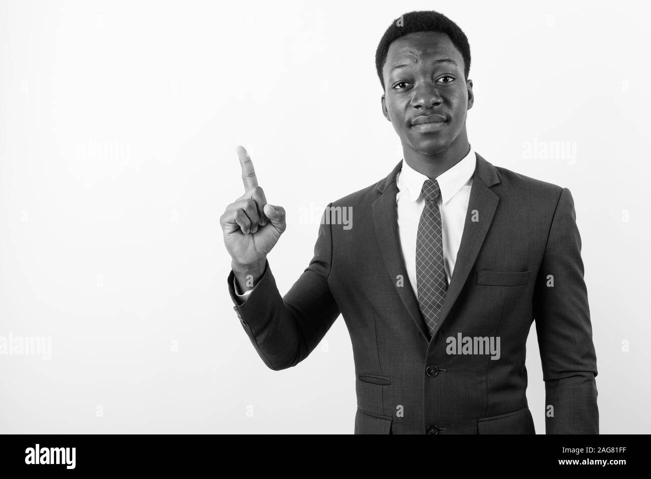 Young handsome African businessman wearing suit against white ...