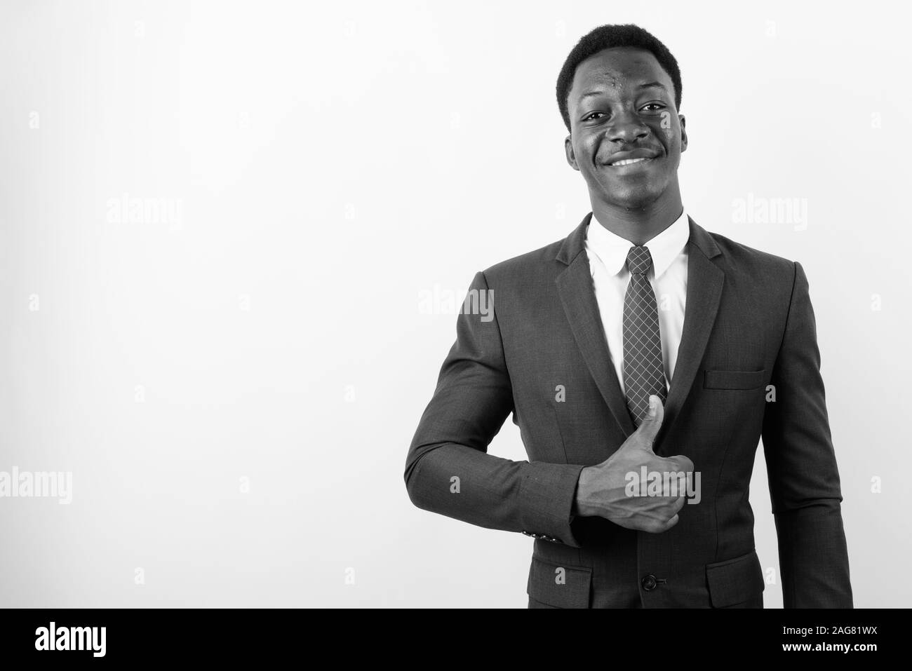 Young handsome African businessman wearing suit against white ...