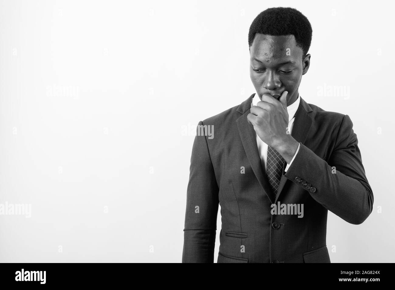Young handsome African businessman wearing suit against white ...