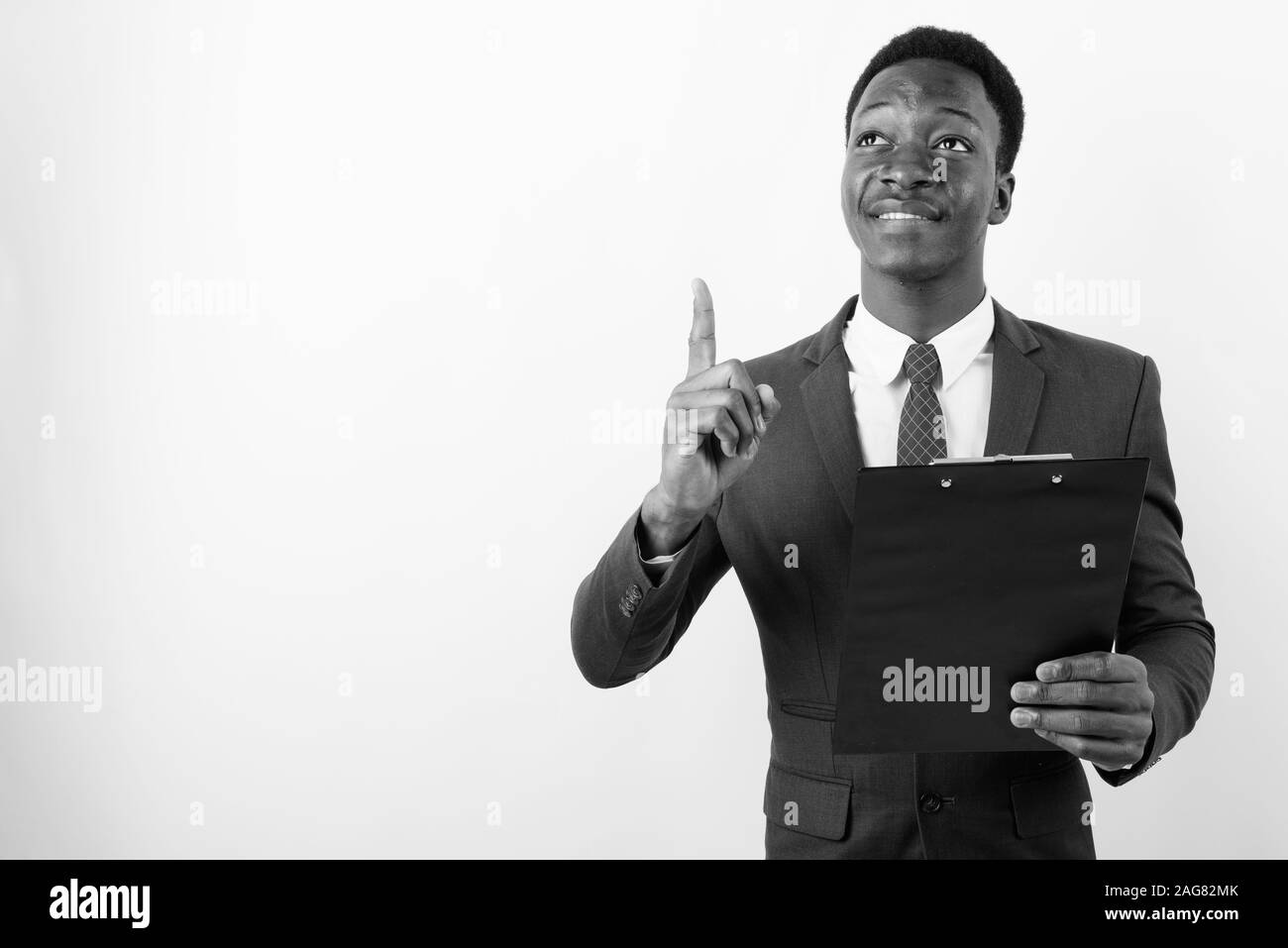Young handsome African businessman wearing suit against white ...