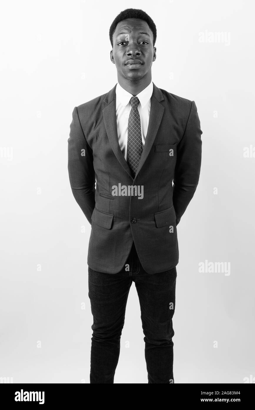 Young handsome African businessman wearing suit against white ...