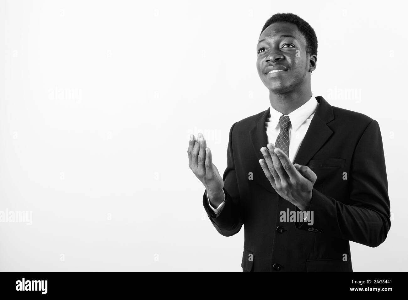 Young handsome African businessman wearing suit against white ...