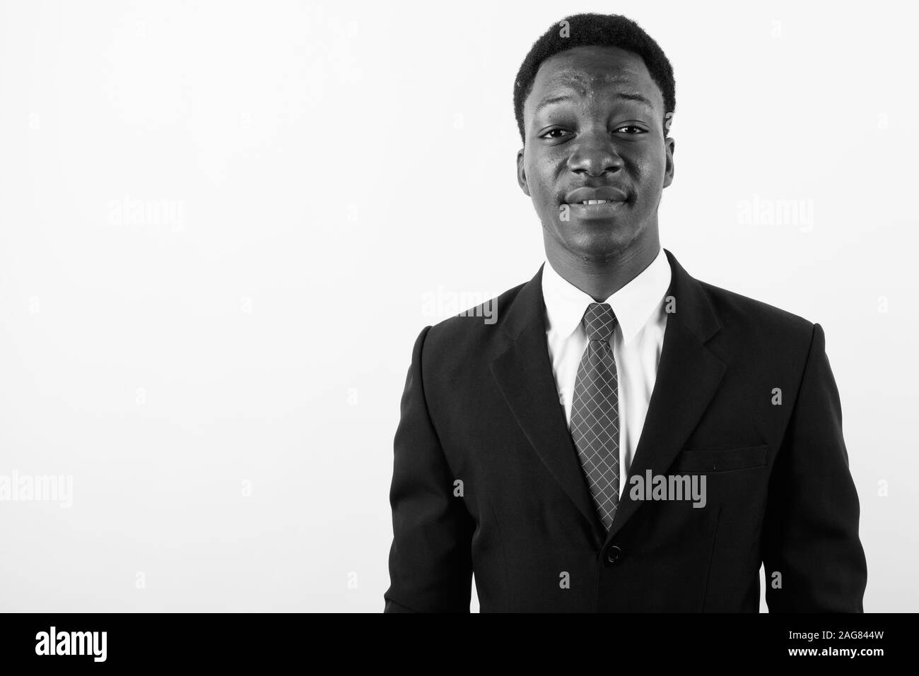 Young handsome African businessman wearing suit against white ...