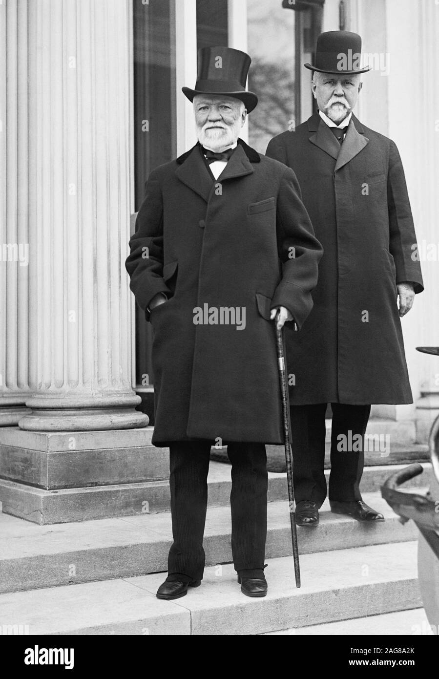 Vintage photo of Scottish-American industrialist and philanthropist Andrew Carnegie (1835 – 1919) and, behind and to the right of him, American banker and politician Theodore P Gilman (1841 – 1930). Photo circa 1914 by Harris & Ewing. Stock Photo