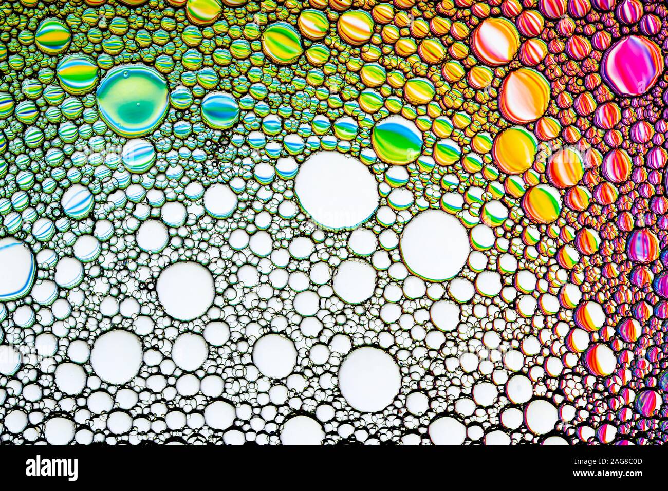 Oil Rings Reflection Colorful drops of oil on the water. Circles and ovals. Abstract bright ...