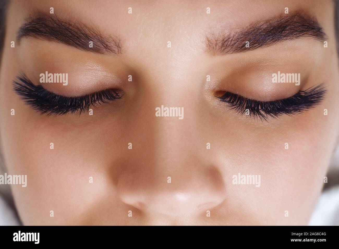 Eyelash Extension Procedure. Woman Eye with Long Blue Eyelashes. Ombre effect. Close up, selective focus. Stock Photo