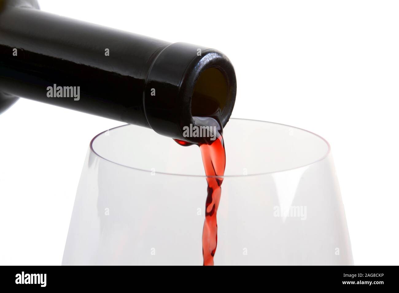drink at the bar - the jet of red wine from the bottle to the glass Stock Photo