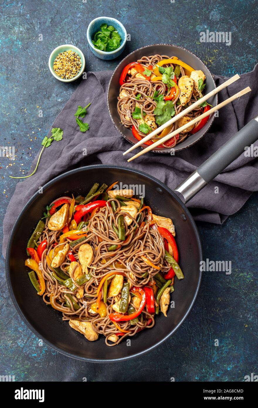 Japanese dish buckwheat soba noodles with chicken and vegetables carrot,  bell pepper and green beans in wok on dark blue background Stock Photo -  Alamy