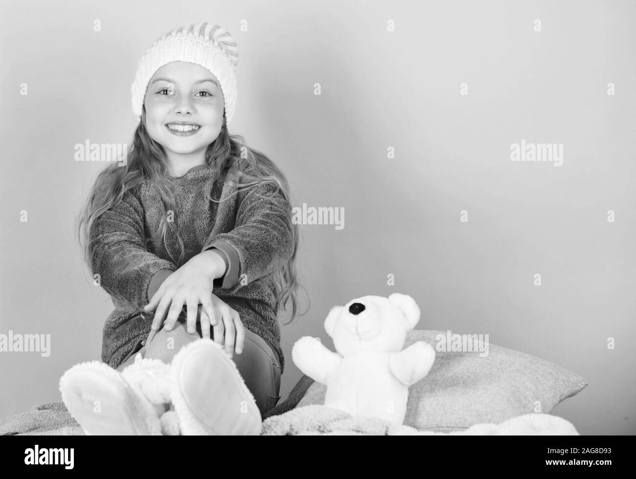 Kid cute girl play with soft toy teddy bear pink background. Teddy bears improve psychological