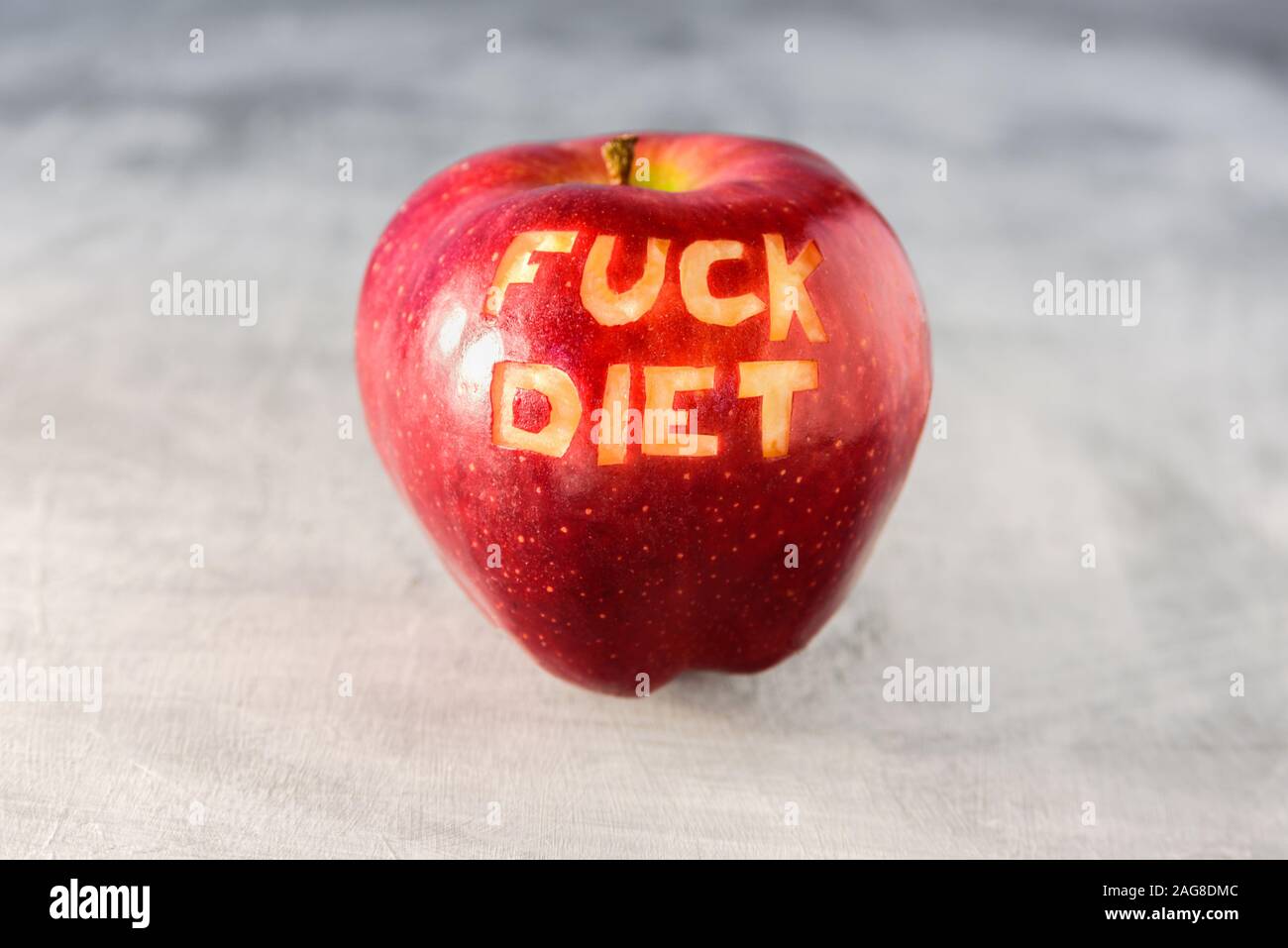 Big red apple on grey background. Dieting and weight loss concept Stock Photo