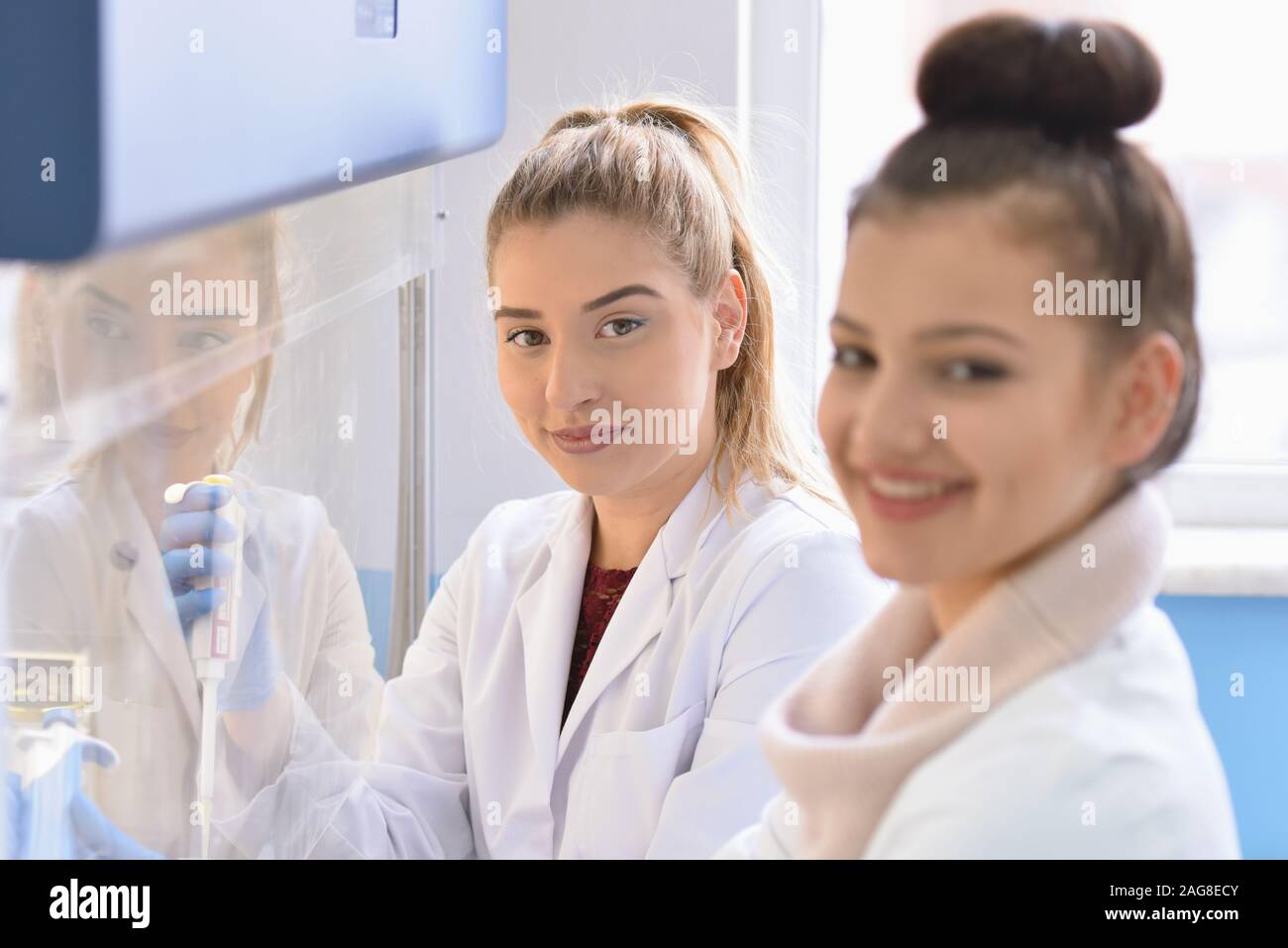 Two Young Female Laboratory scientist working at lab with test tubes ...