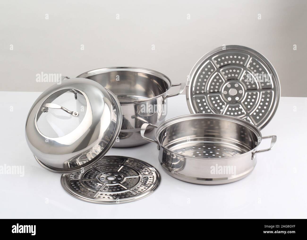 set of stainless steel pots isolated on white background Stock Photo