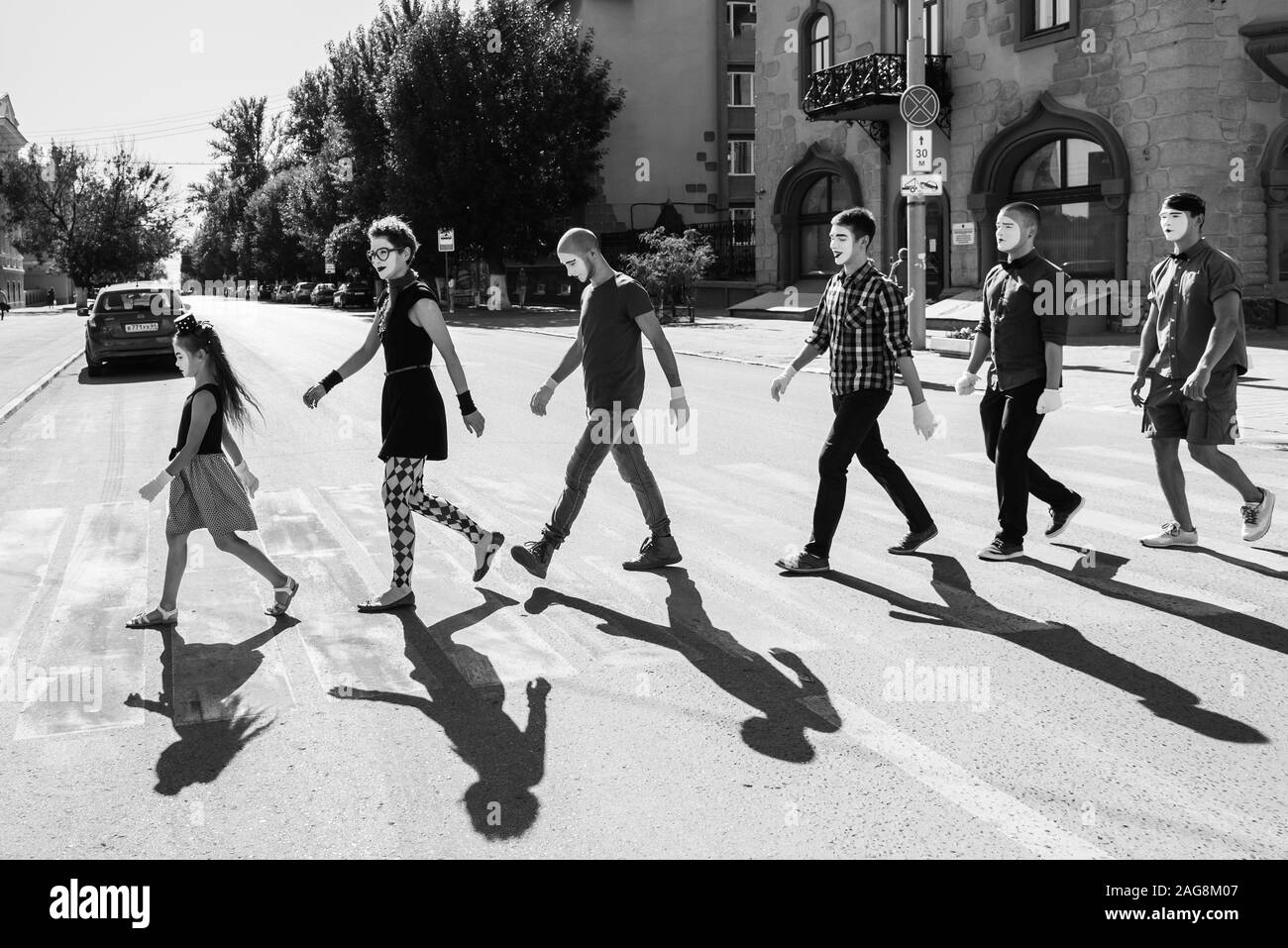 the team of mimes crosses the road stepping on the transition Stock Photo