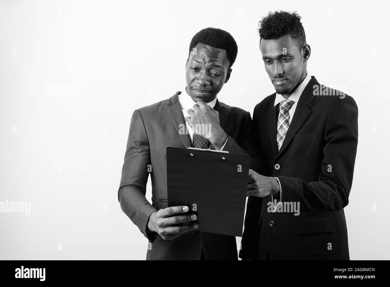 Two young African businessmen against white background Stock Photo