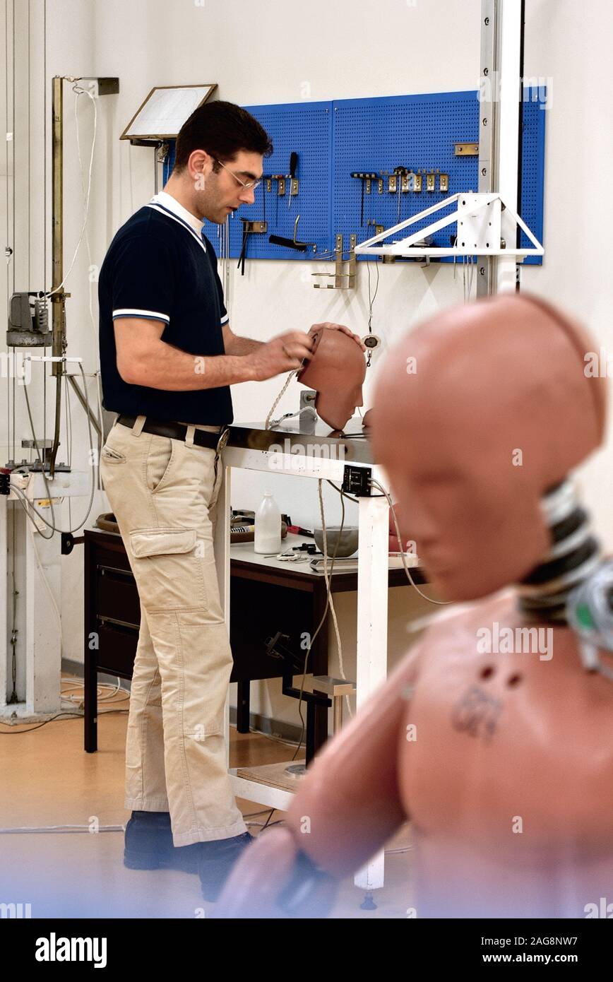 A technician carries out repairs to crash test dummies which have been damaged in the course of the tests they have undergone. Stock Photo