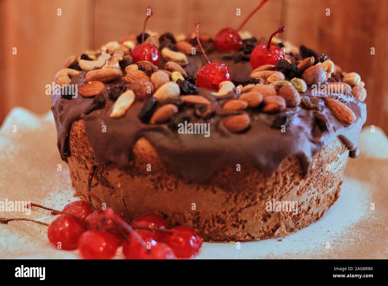 A Closeup Shot Of A Delicious Chocolate Cake With Cherries And
