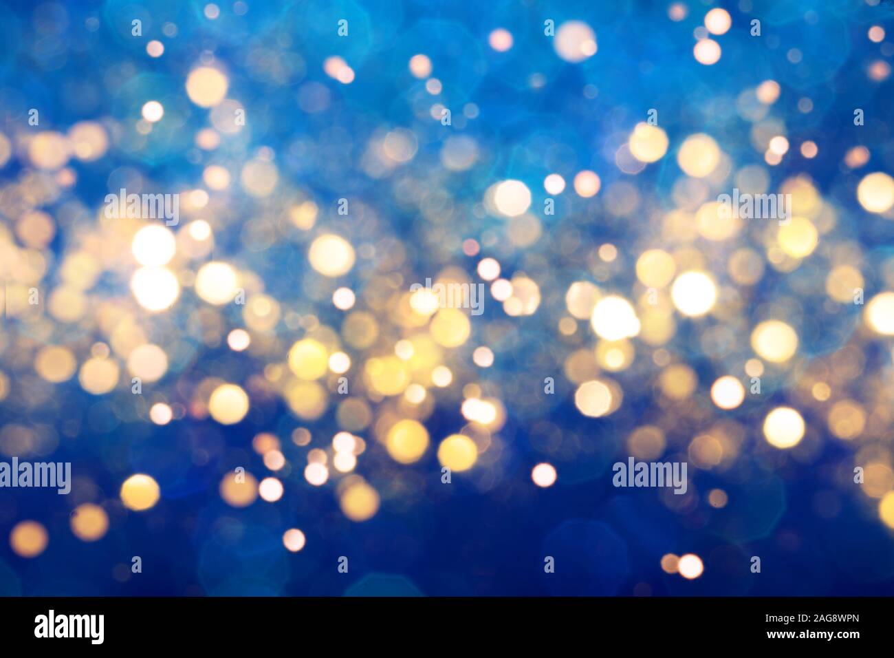 Blue festive background with sparkles in the bokeh. The concept of the celebration, the day of Christmas, New Year, birthday, ceremonies, events, etc. Stock Photo