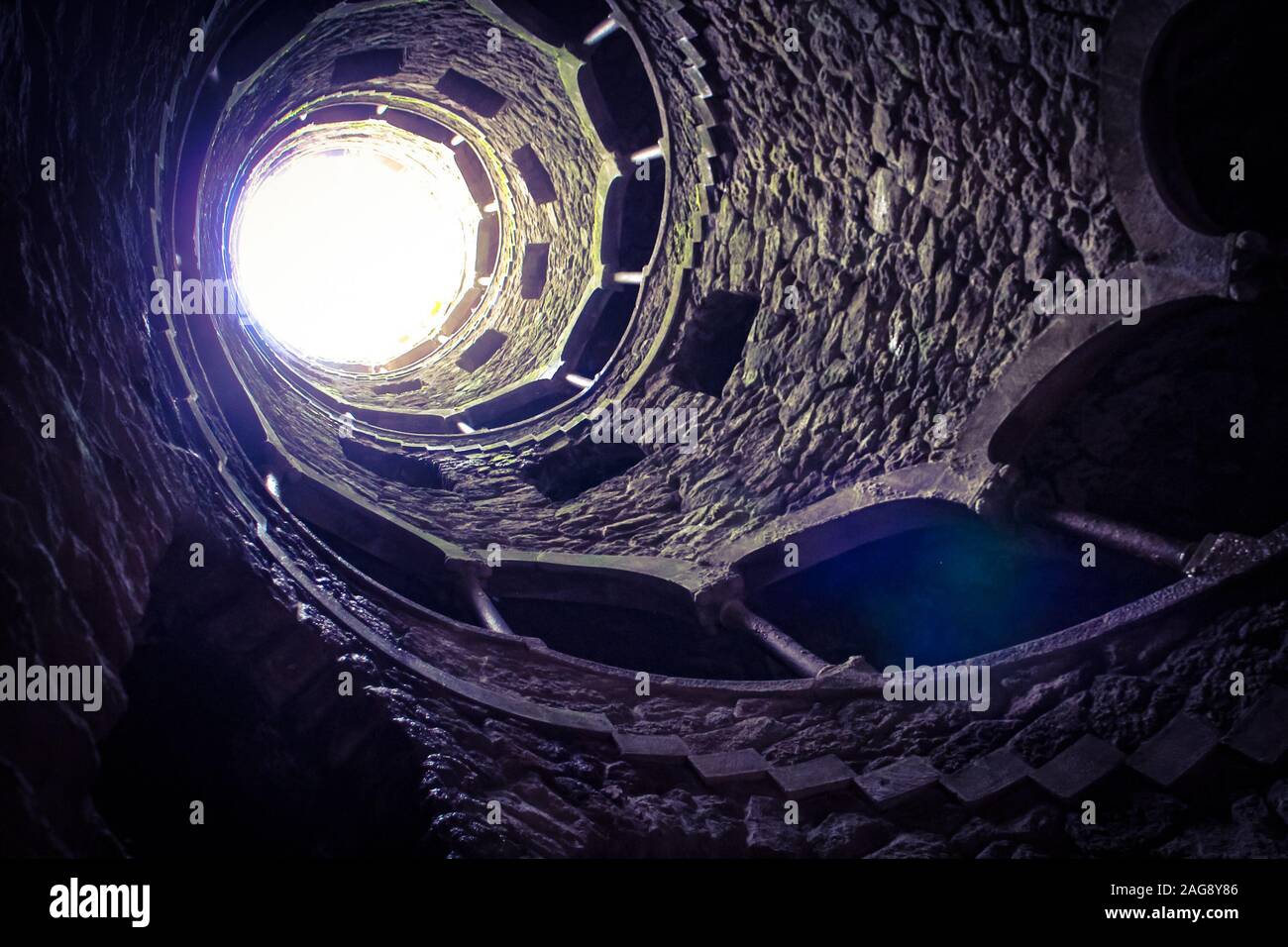 The view upwards in the Initiation Well of Quinta da Regaleira, Sintra, Portugal, part of the 'Cultural Landscape of Sintra' UNESCO world heritage. Stock Photo