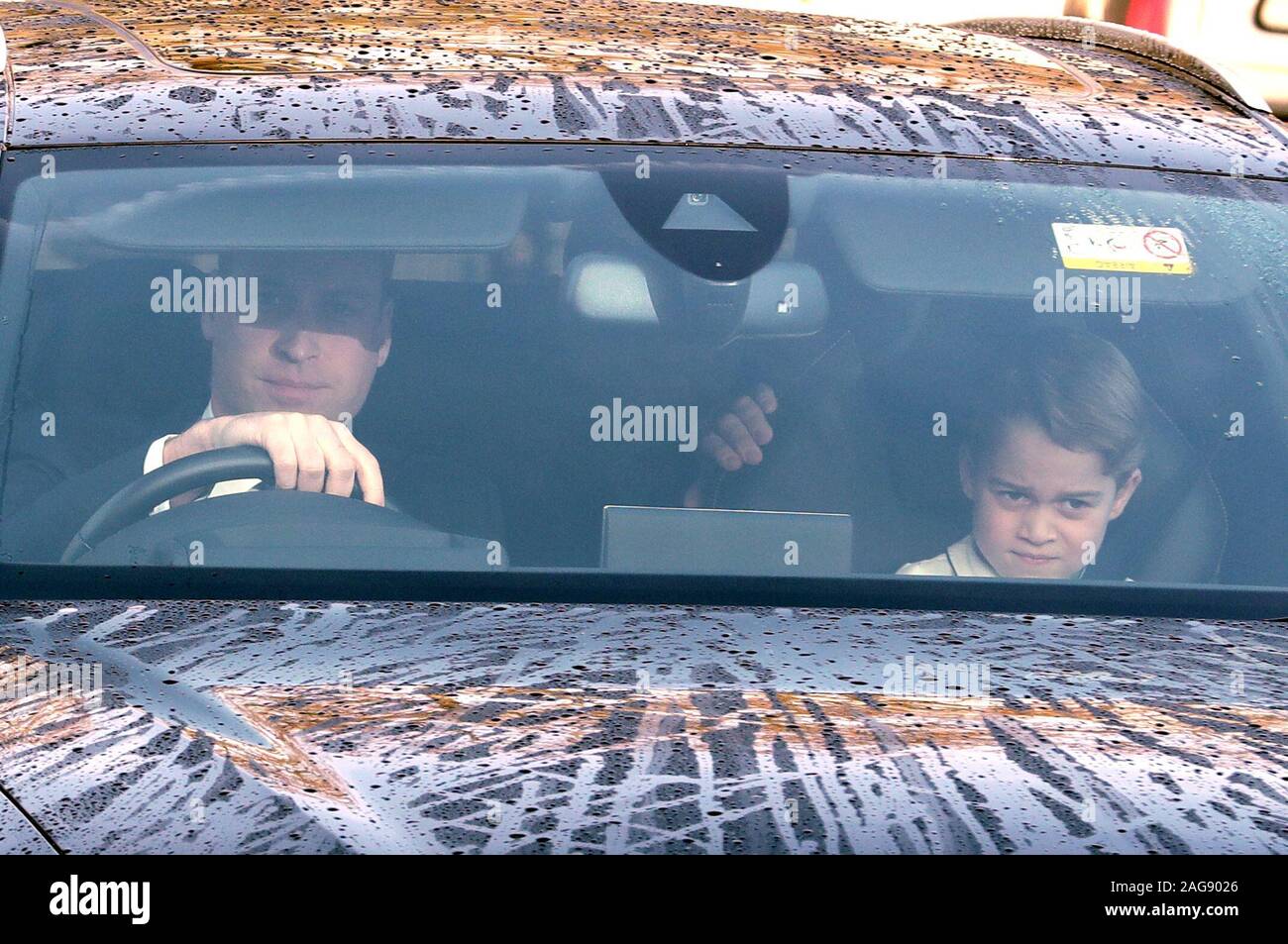 Prince sits in the front passenger seat next to his father the