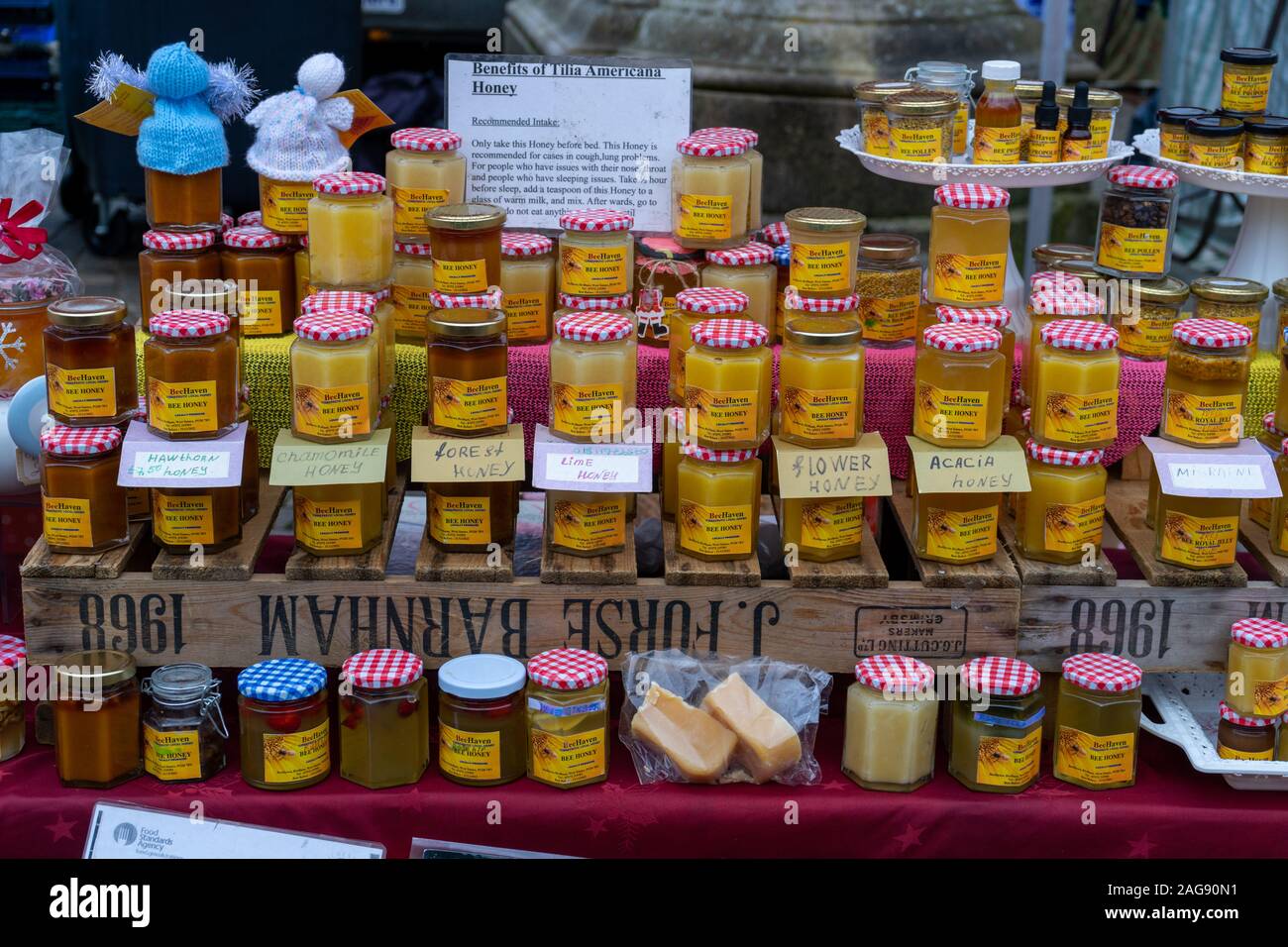 Various types of honey in honey jars for sale on a market stall Stock