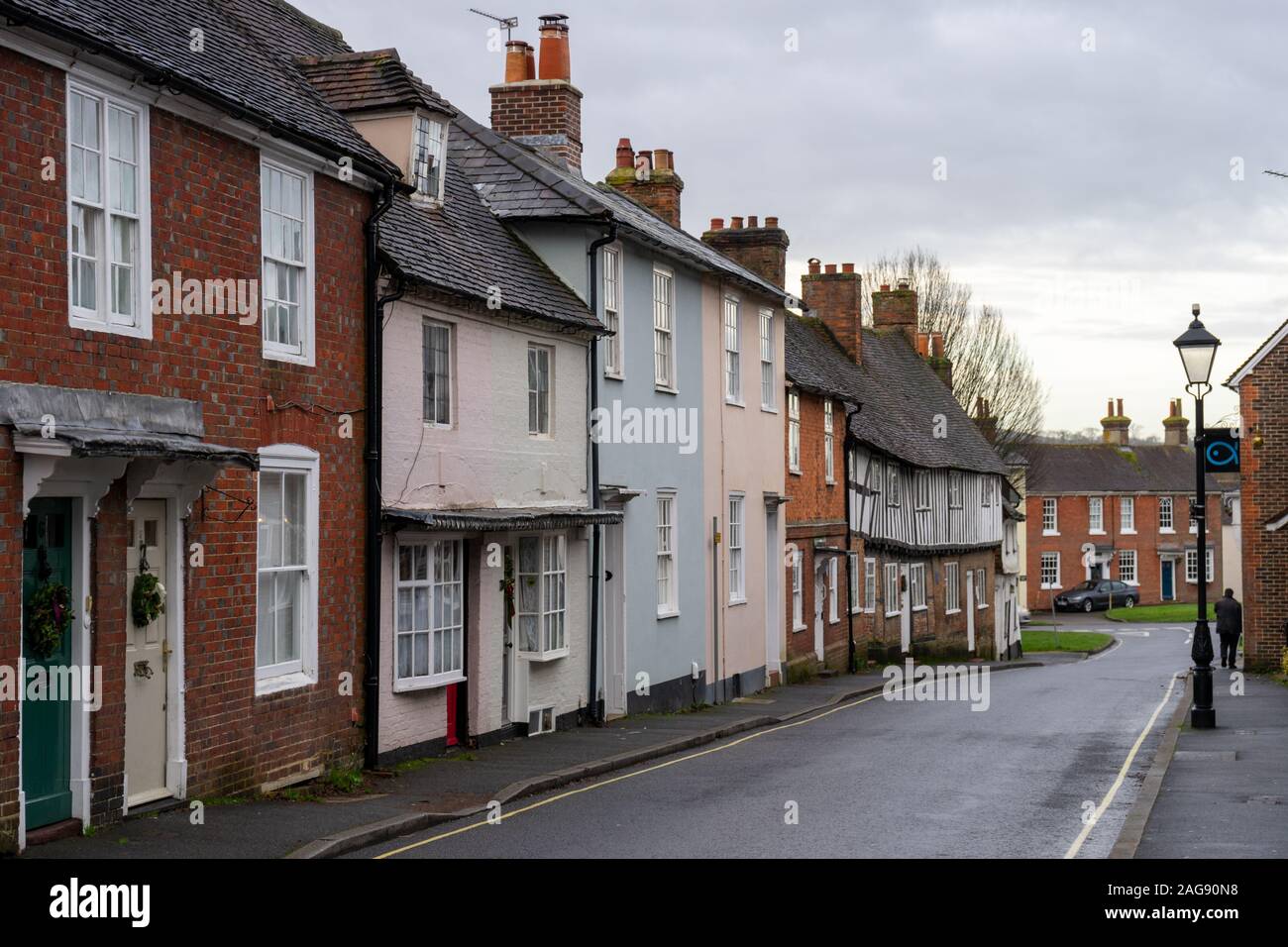 A street lined with typical old English houses and cottages with a Victorian lamp post Stock Photo