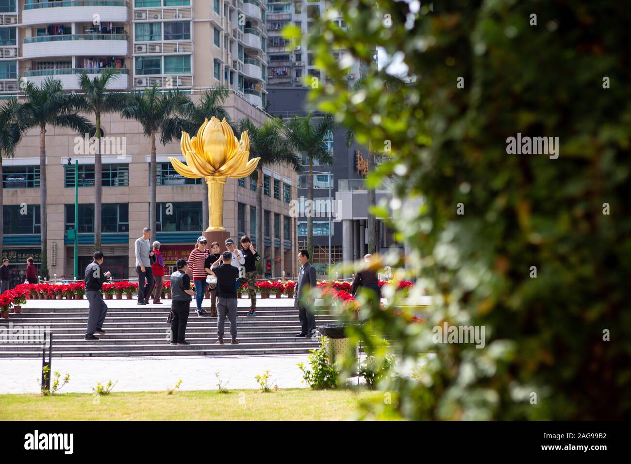 Macao, China. 18th Dec, 2019. People pose for photos at the Golden Lotus Square in Macao, south China, Dec. 18, 2019. Over the past two decades, the special administrative region has made great strides in economic development and achieved prosperity and stability under the 'one country, two systems' principle. Credit: Li Jing/Xinhua/Alamy Live News Stock Photo