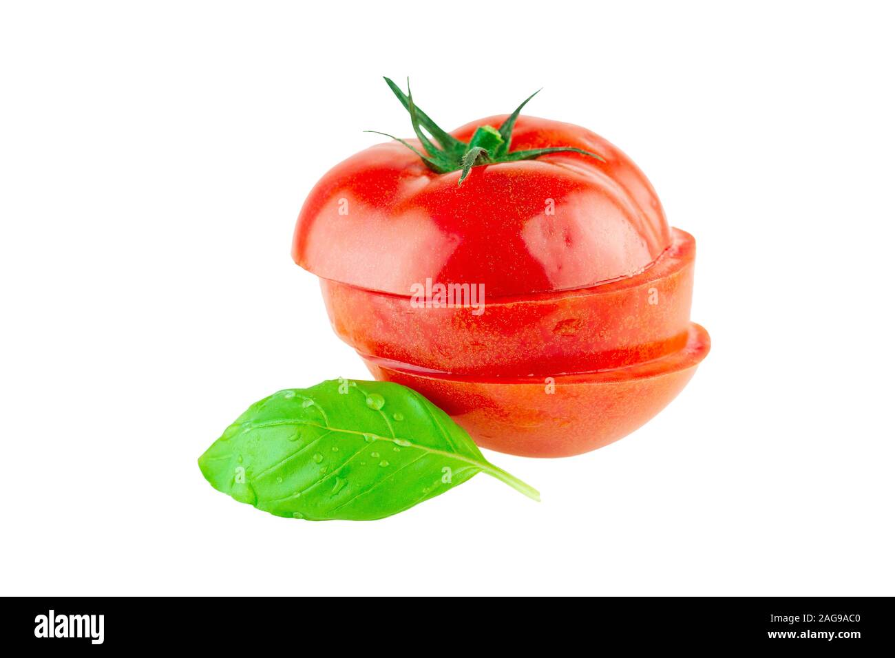 Tomato sliced in a pile with basil leaf isolated on white Stock Photo