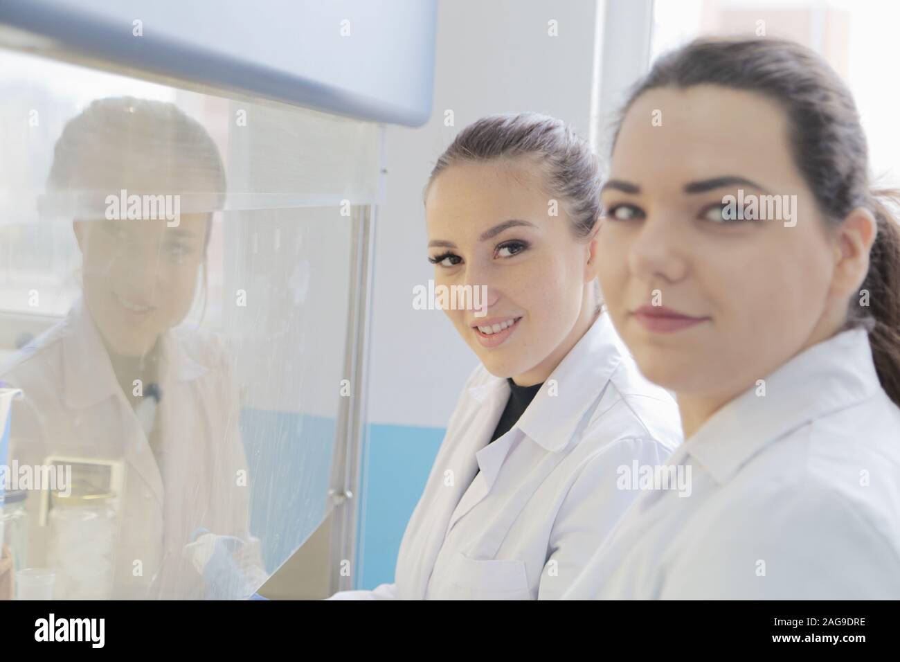 Two young female Laboratory scientists working at lab with test tubes ...