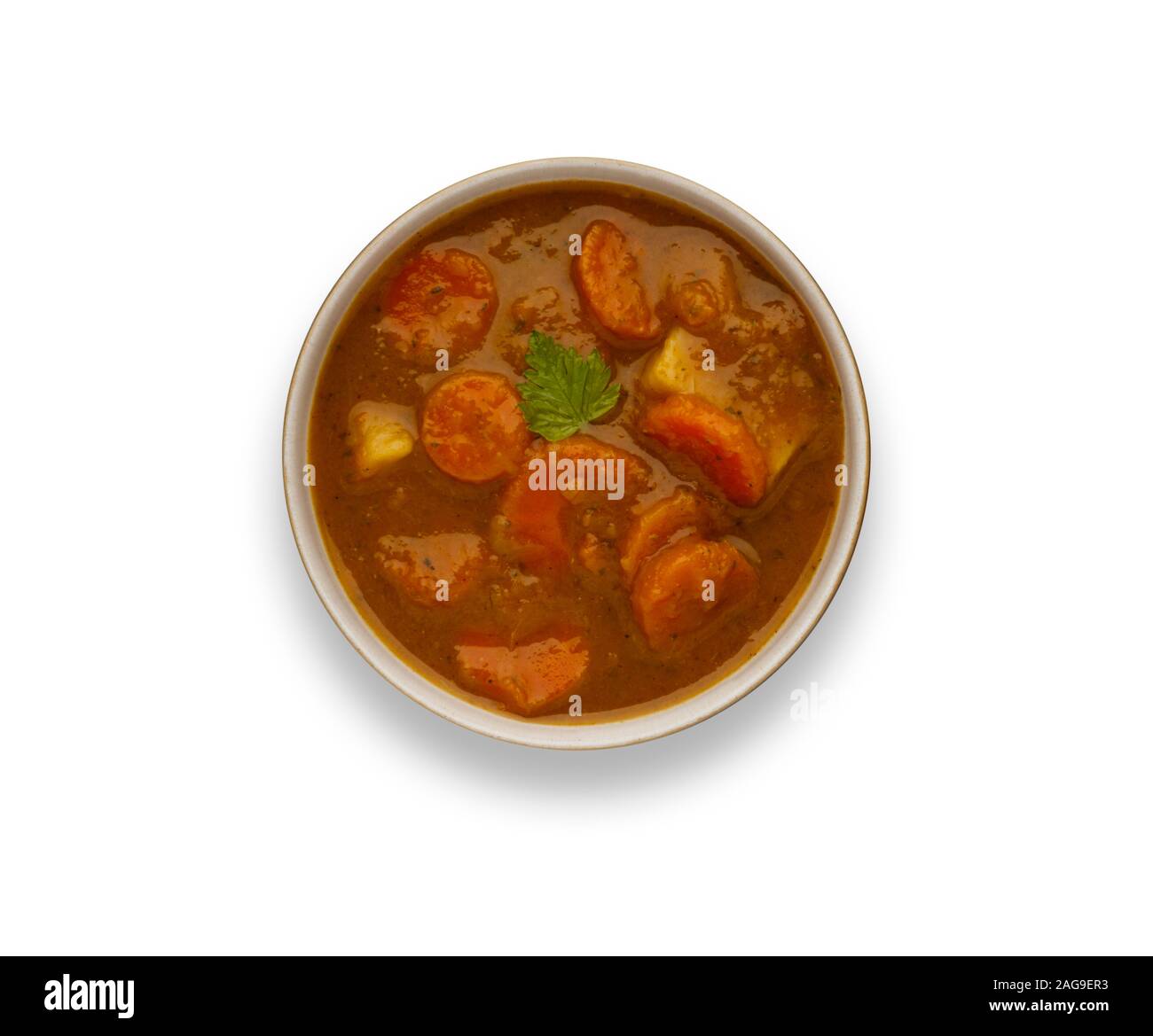 Isolated image of a bowl of delicious hearty winter vegetable soup, in a rustic bowl, with a drop shadow. Stock Photo