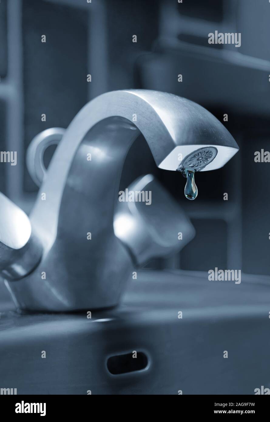 Wasteful use of water by leaking faucet Stock Photo