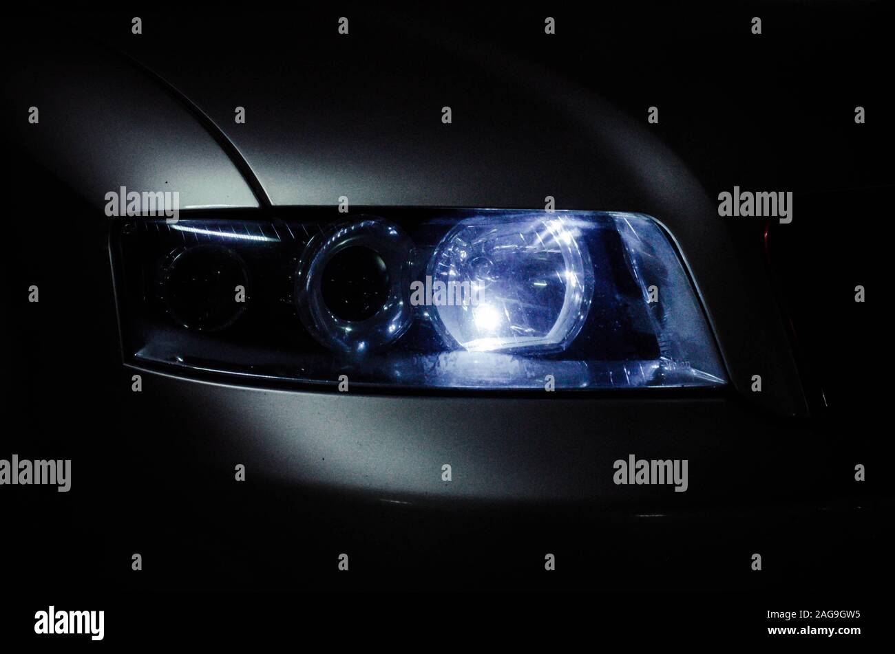 Headlight of the car with the included lamps. Car headlight illuminates the dark Stock Photo Alamy