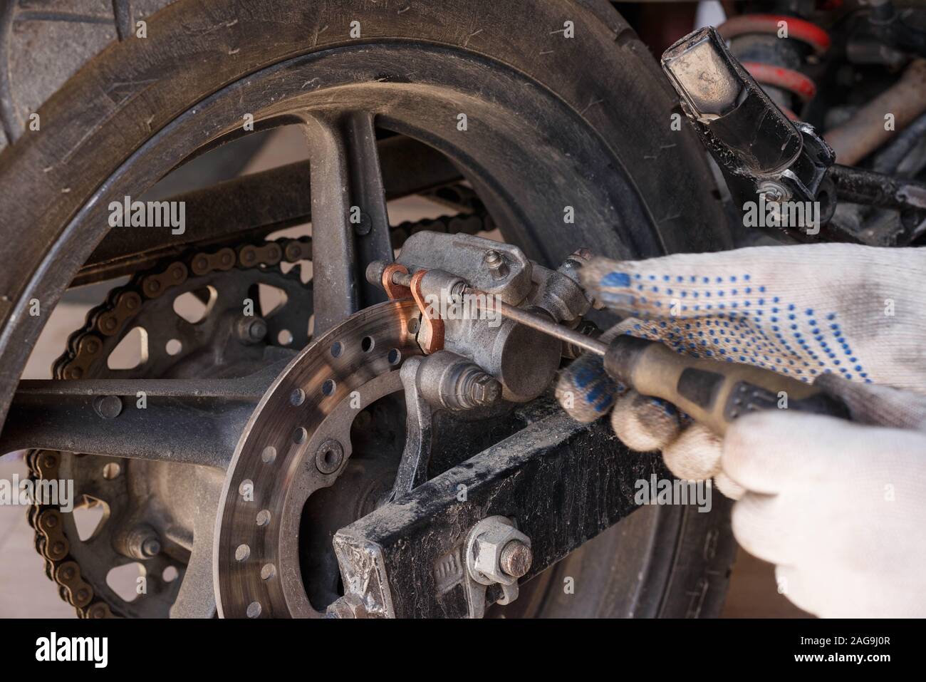 The process of replacing brake pads on a motorcycle. Maintenance
