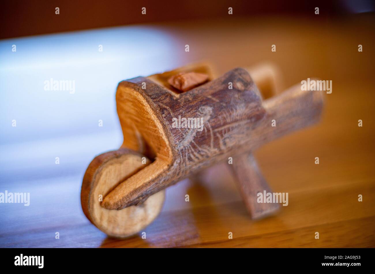 High angle selective focus shot of a wooden figurine looking like a trigger Stock Photo
