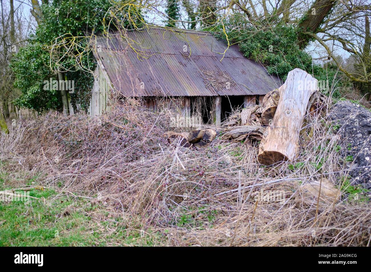 An barn that has been made from metal sheets that has not been used for a long time and has allowed to fall into a state of disrepair Stock Photo