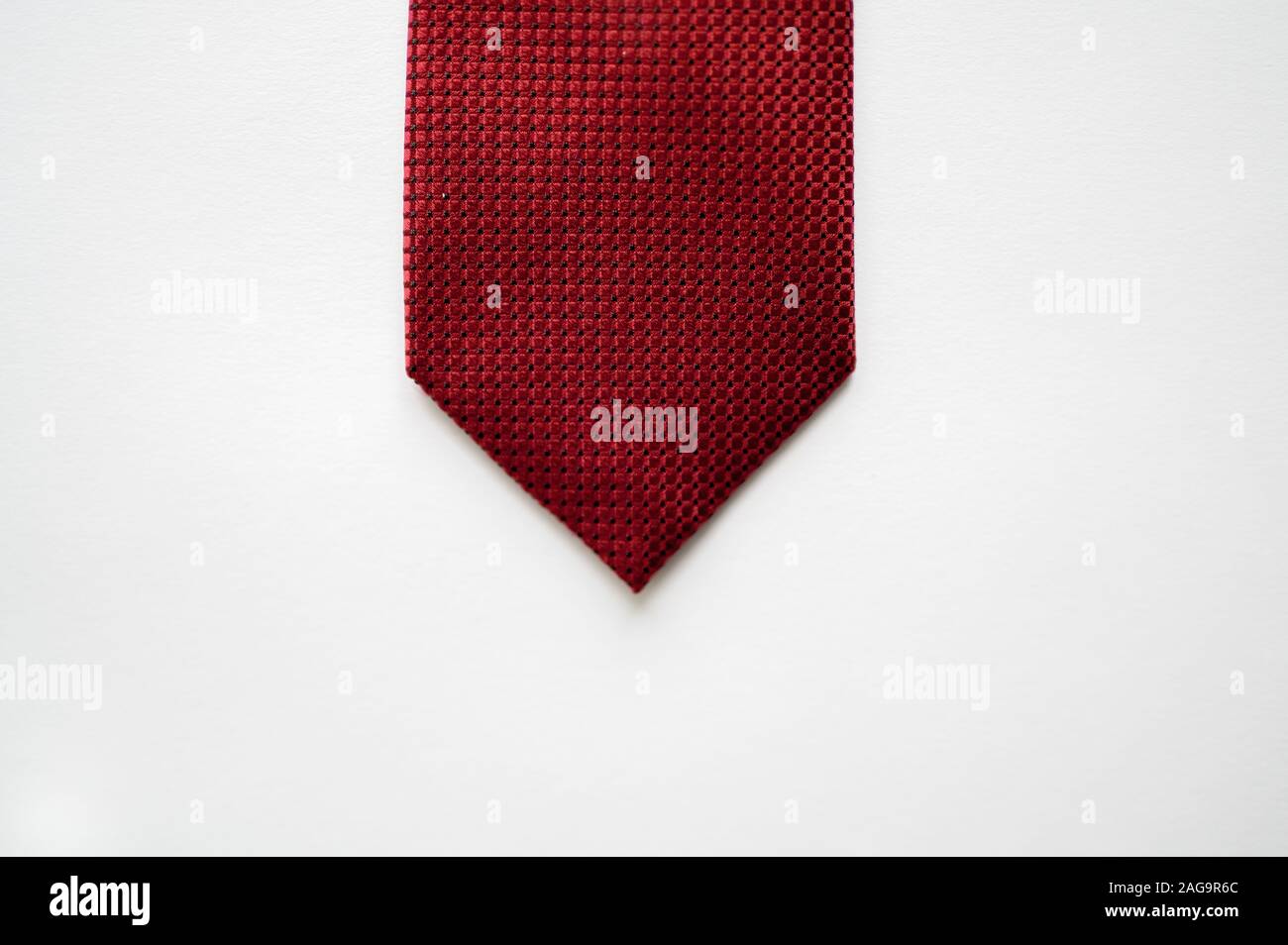 Overhead shot of a red tie on a white surface Stock Photo