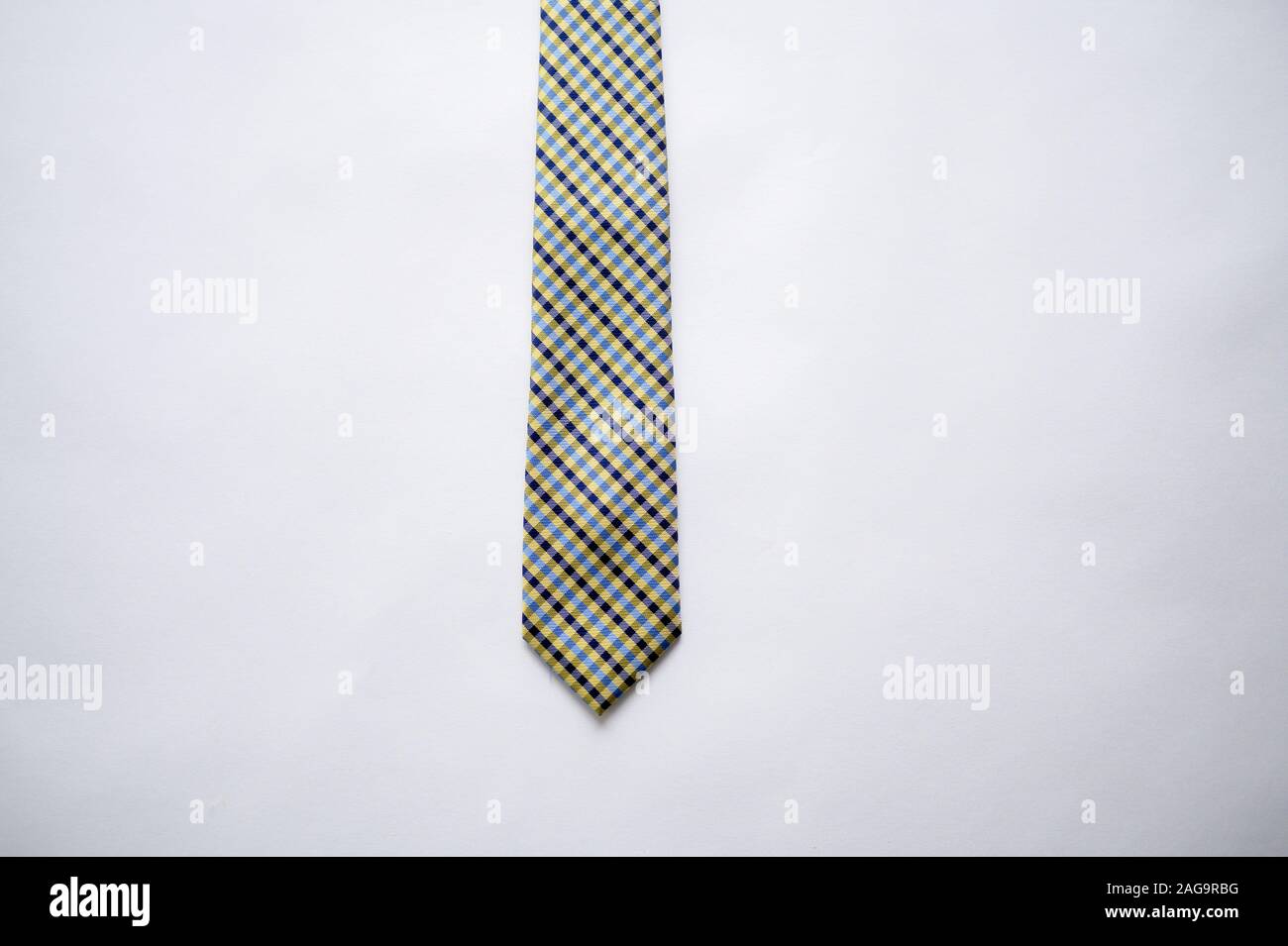Overhead shot of a striped tie on a white surface Stock Photo