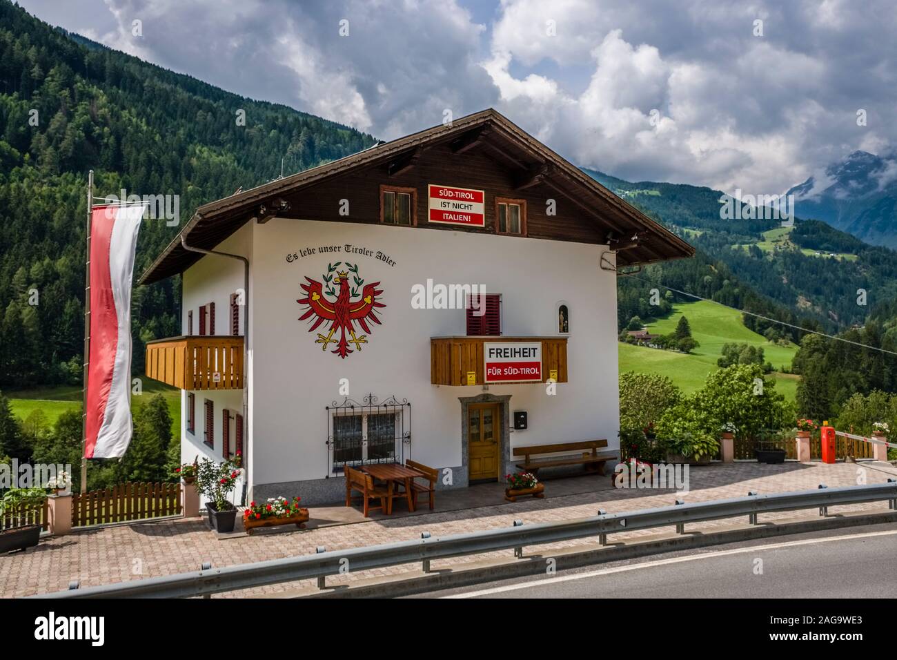 House with signposts attached, regarding the political movement Freedom for South Tyrol, Freiheit für Südtirol Stock Photo