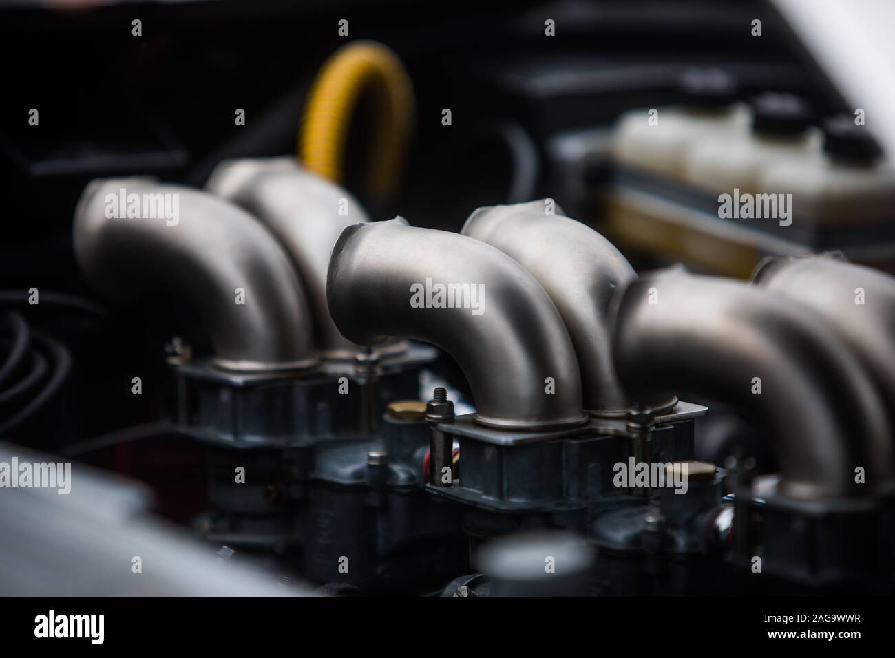 Color close up of the air intake hoses of a sports engine of a car