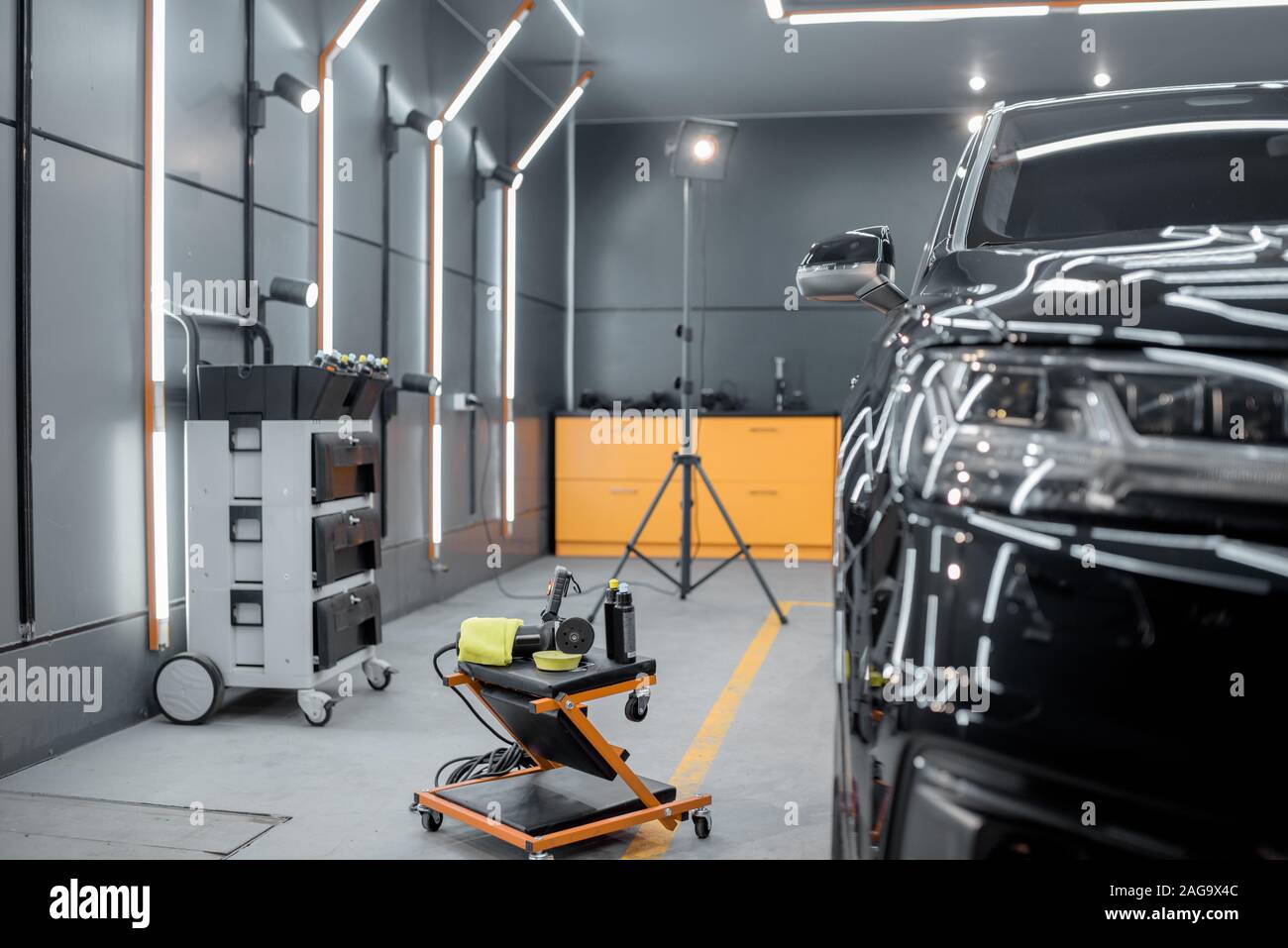 Car service station with luxury car prepared for the body polishing